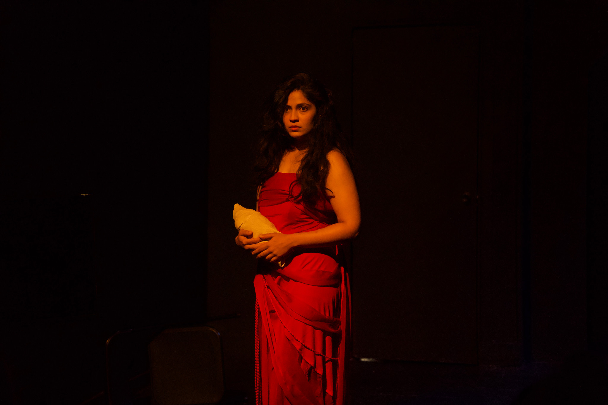 Her Rage performer in a red dress holding a prop