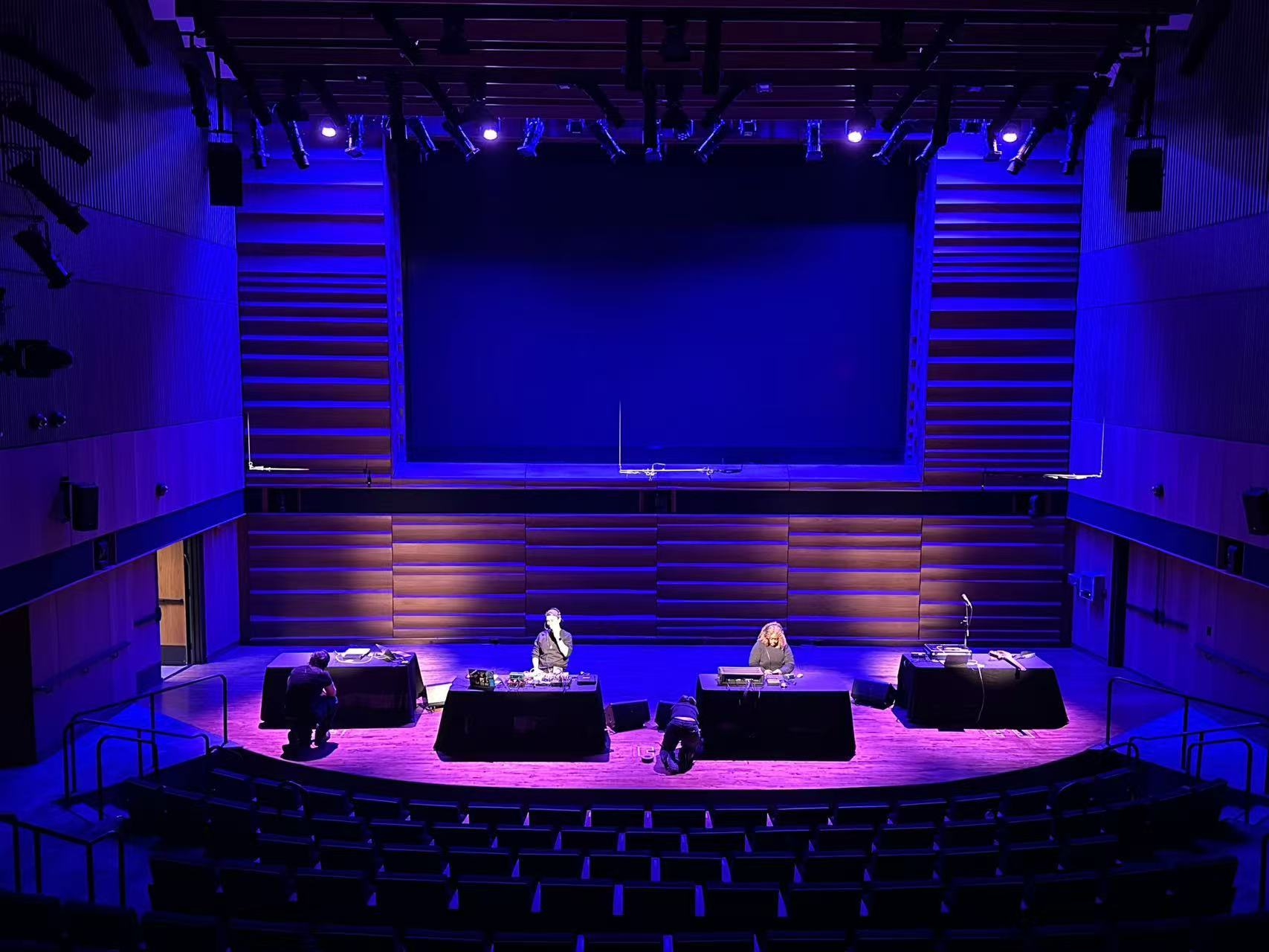 SuperCollider Symposium stage under blue and violet lighting